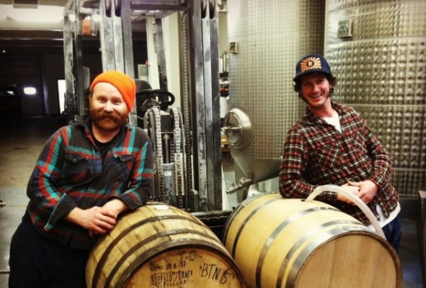 Brewers leaning on casks