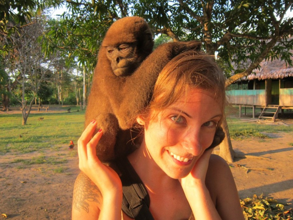A human gives a monkey a piggy-back ride