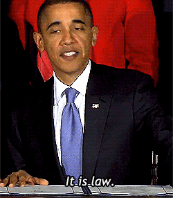 Obama slaps a table, "It is law."