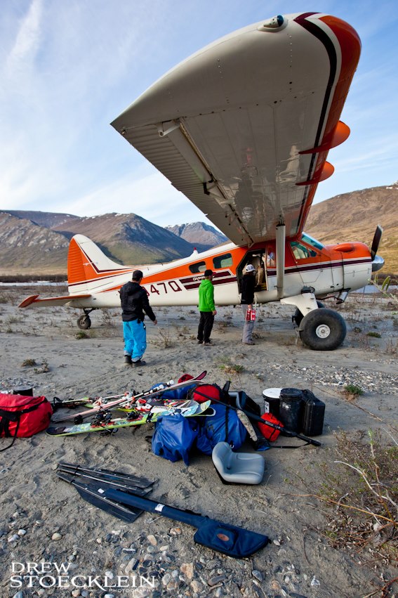 People with gear by a bush plane