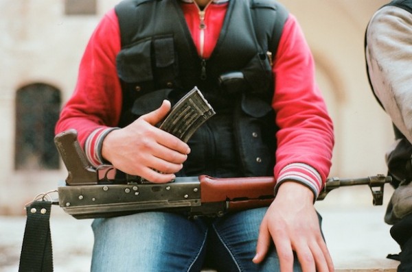 A person holding gun on lap