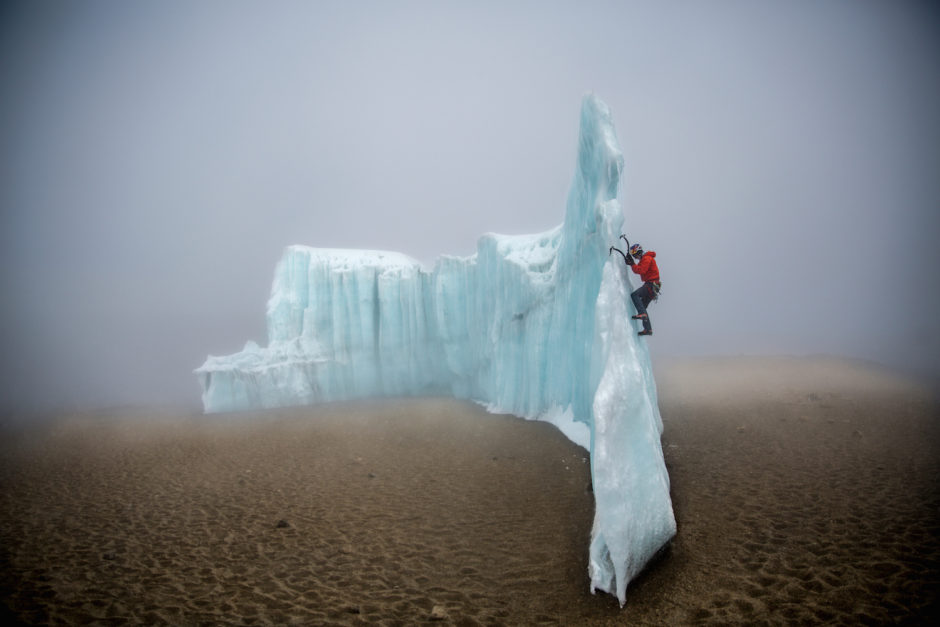 Will Gadd ice climbing near the summit at 19,000 feet on the glacier ice on Mount Kilimanjaro, Tanzania, Africa.  