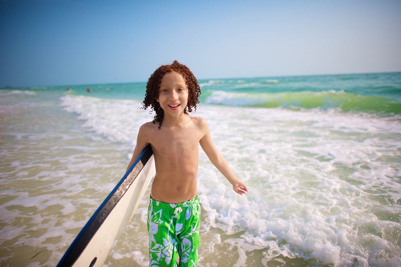 Boy sandboard Florida beach