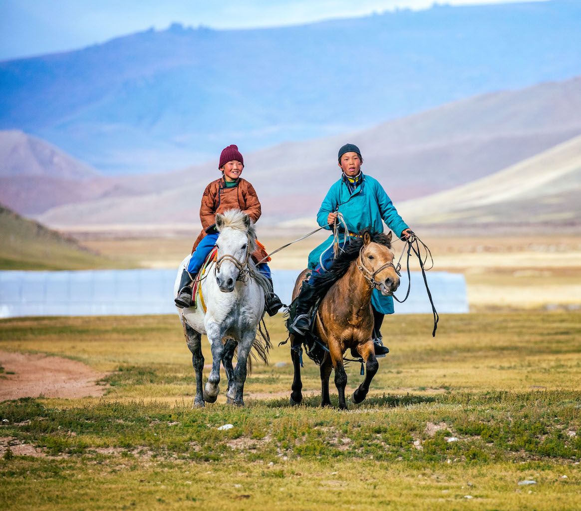 Mongolia_two teenagers on horses