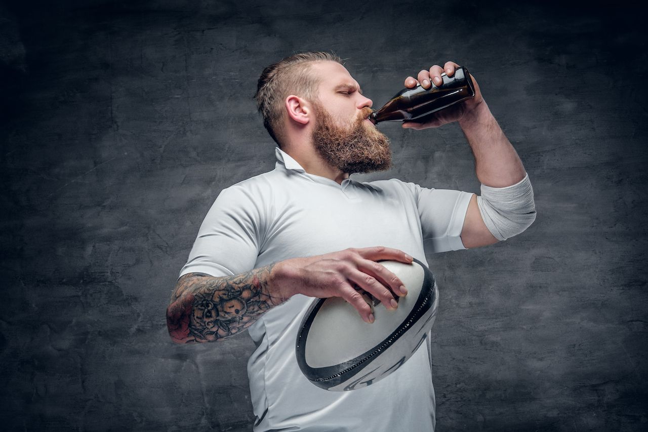 Rugby player drinking non-alcoholic beer