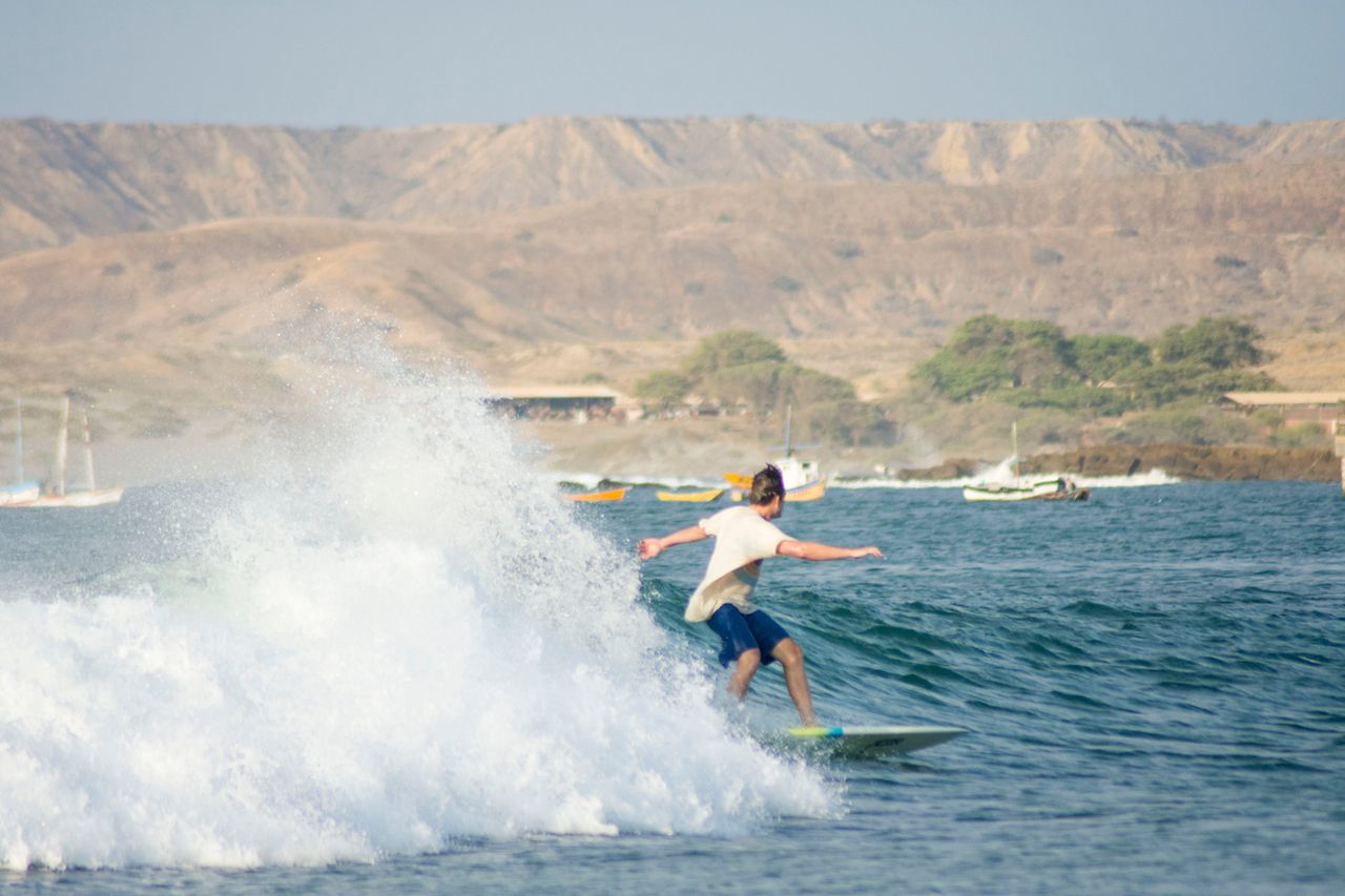 Riding a wave in Lobitos, Peru