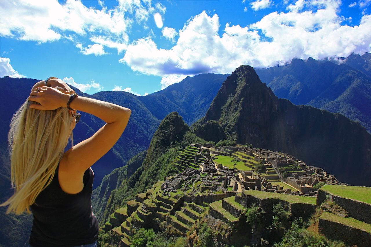 Young woman looking at Machu Picchu