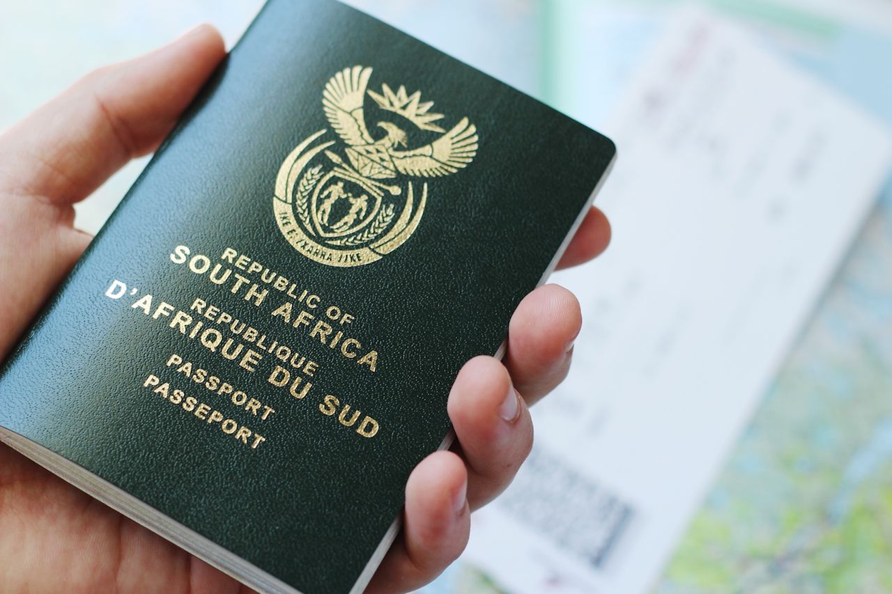 hand holding South African passport