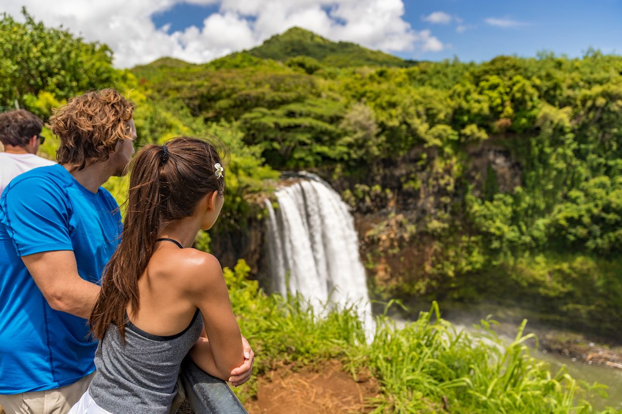 Tourists at Hawaii Kauai waterfall