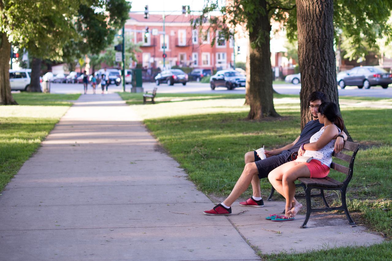 A young couple relaxes in Palmer Square Park in the Logan Square neighborhood