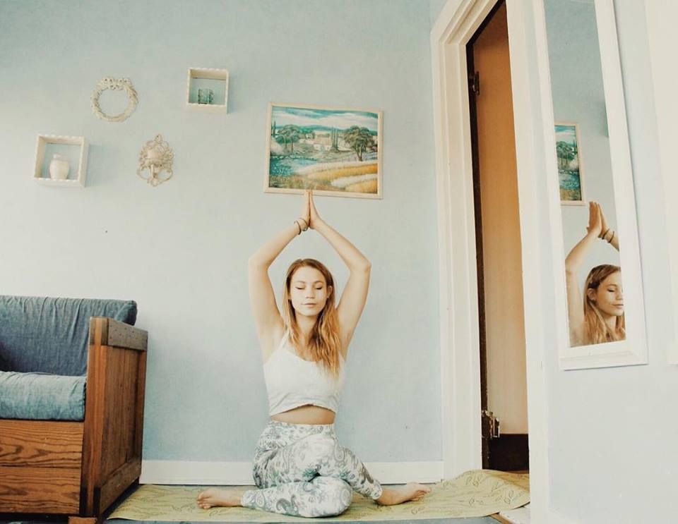 Woman doing yoga inside a room