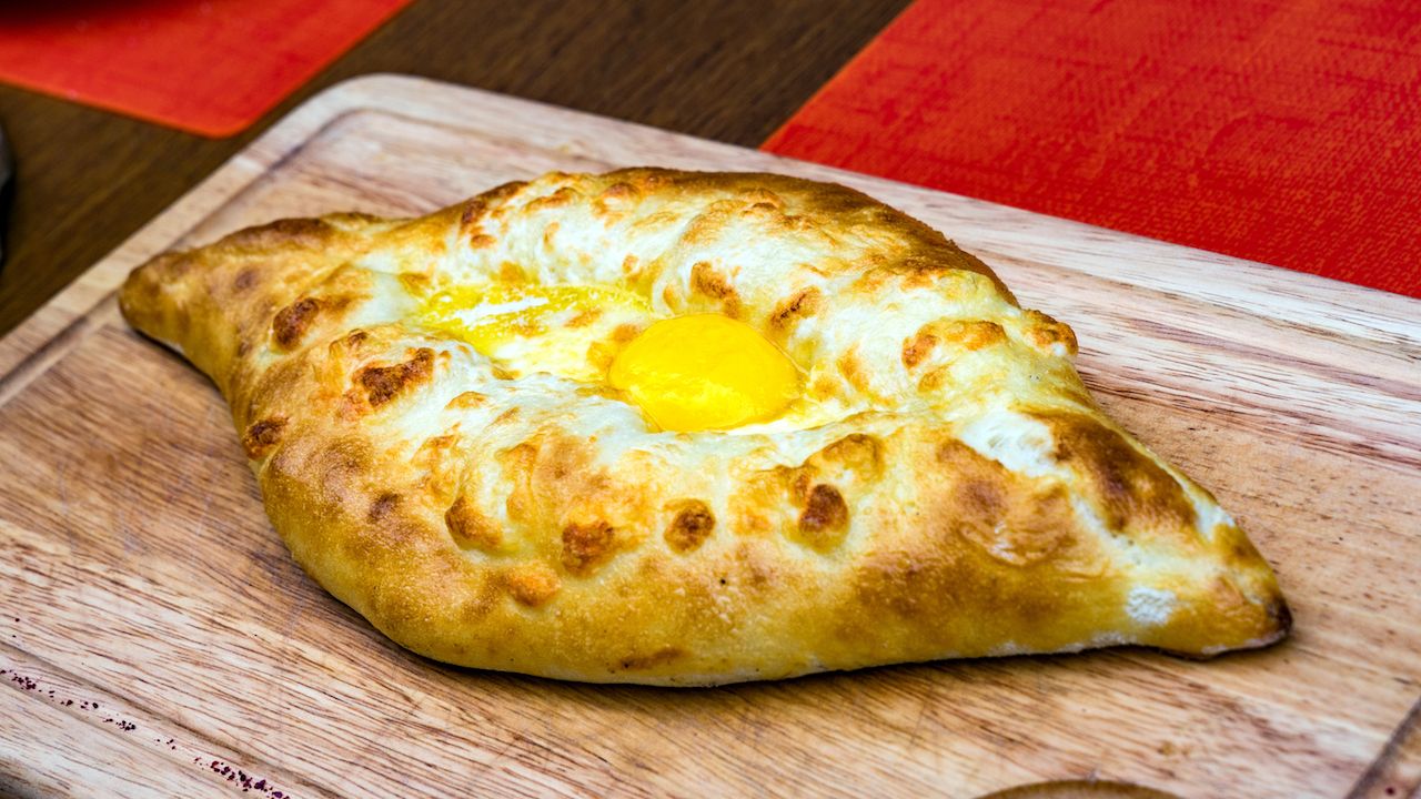 traditional Georgian dish Adjarian Khachapuri with egg and cheese