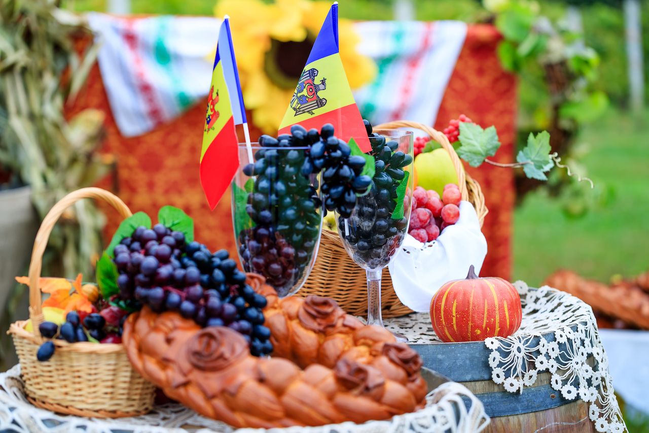 Moldovan picnic with national flag and grapes in wine glasses