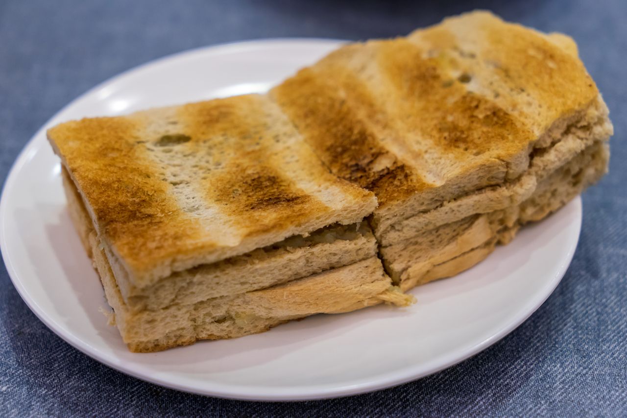 Traditional Singapore Breakfast called Kaya Toast, Bread with Coconut Jam and butter, Selective Focus technique