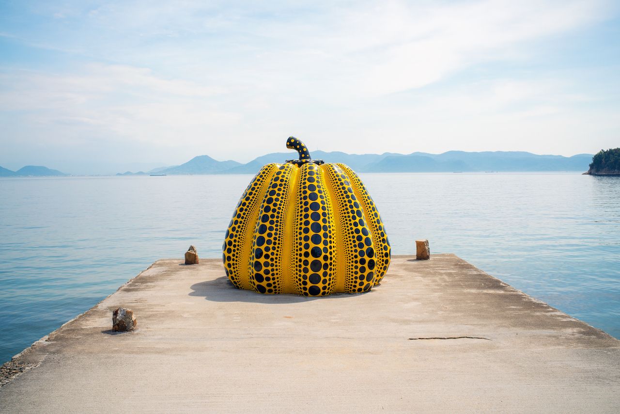 Yayoi Kusama giant pumpkin sculpture in front of the sea on Naoshima Art Island in Japan