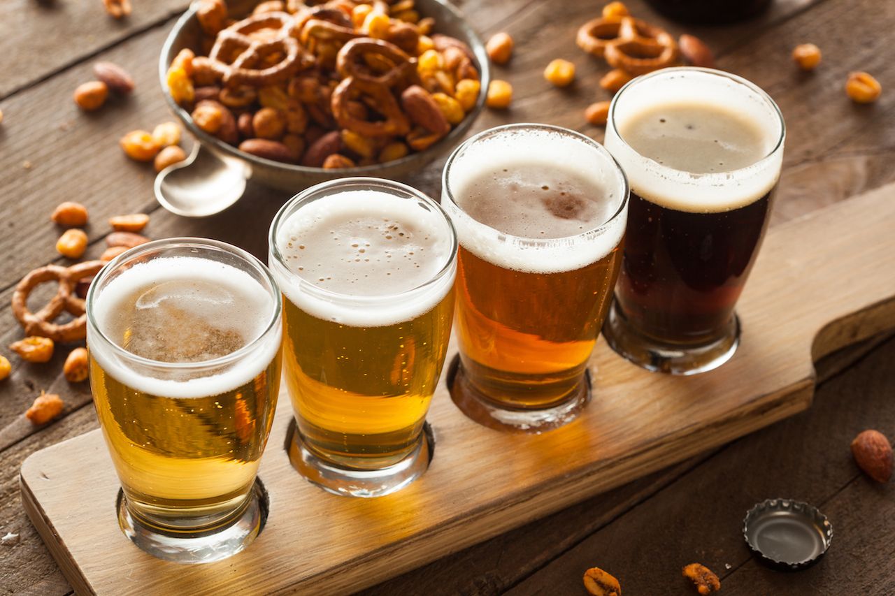 flight of beer with pretzels and peanuts