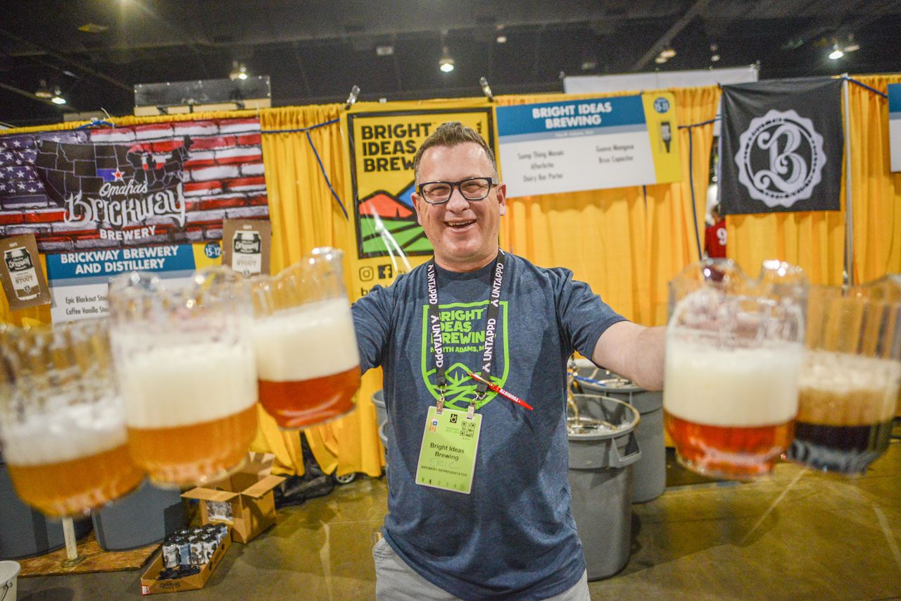 Man holding beer pitchers at the Great American Beer Festival
