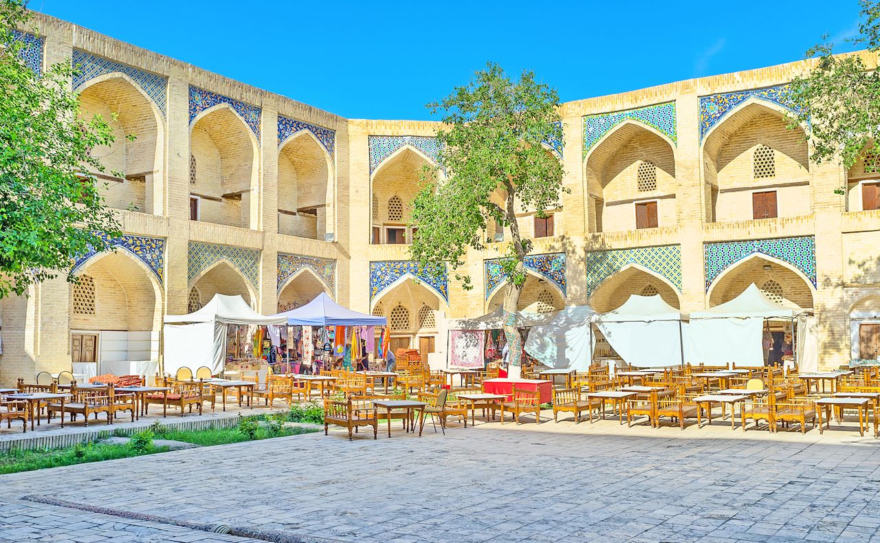 restaurant and souvenir market in the courtyard of Nadir Divan-Beghi Madrasah in Bukhara, Uzbekistan