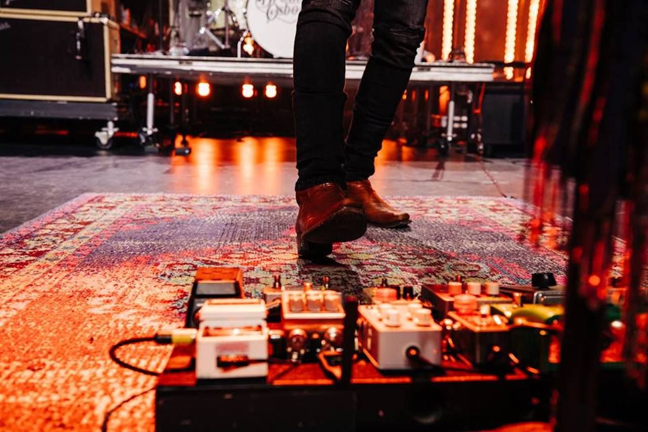 Musician in front of a stage with foot pedals