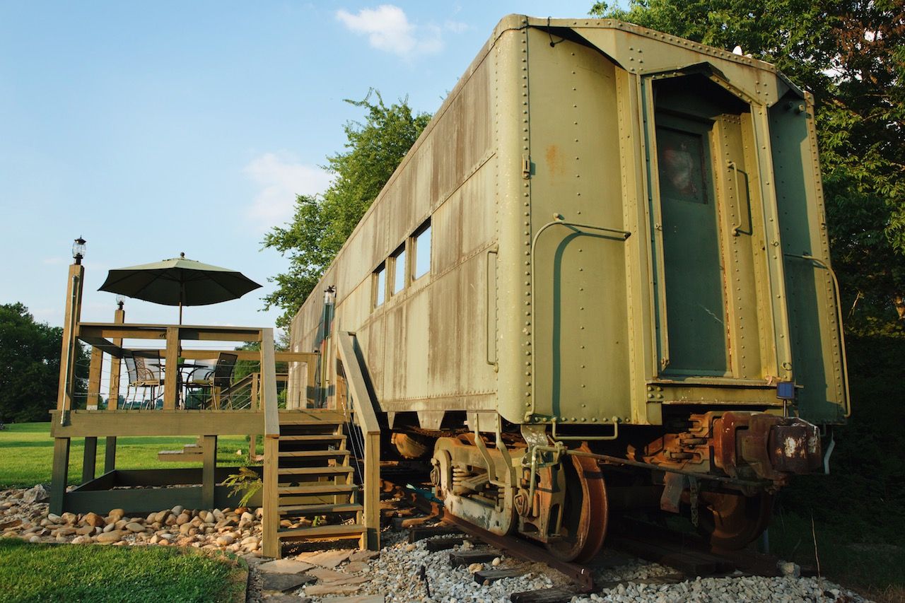 Green train car turned Airbnb