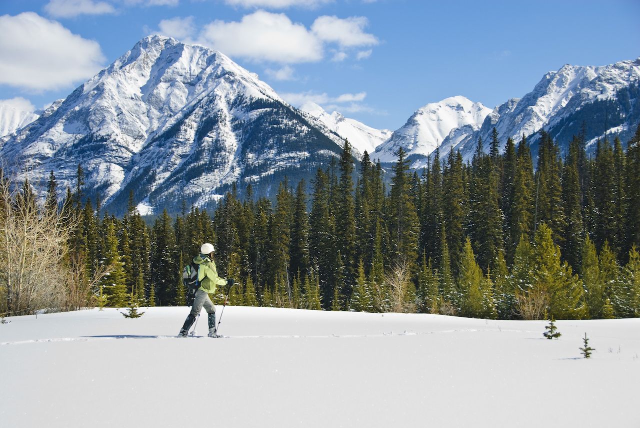 Woman snowshoeing in Banff National Park, Canada