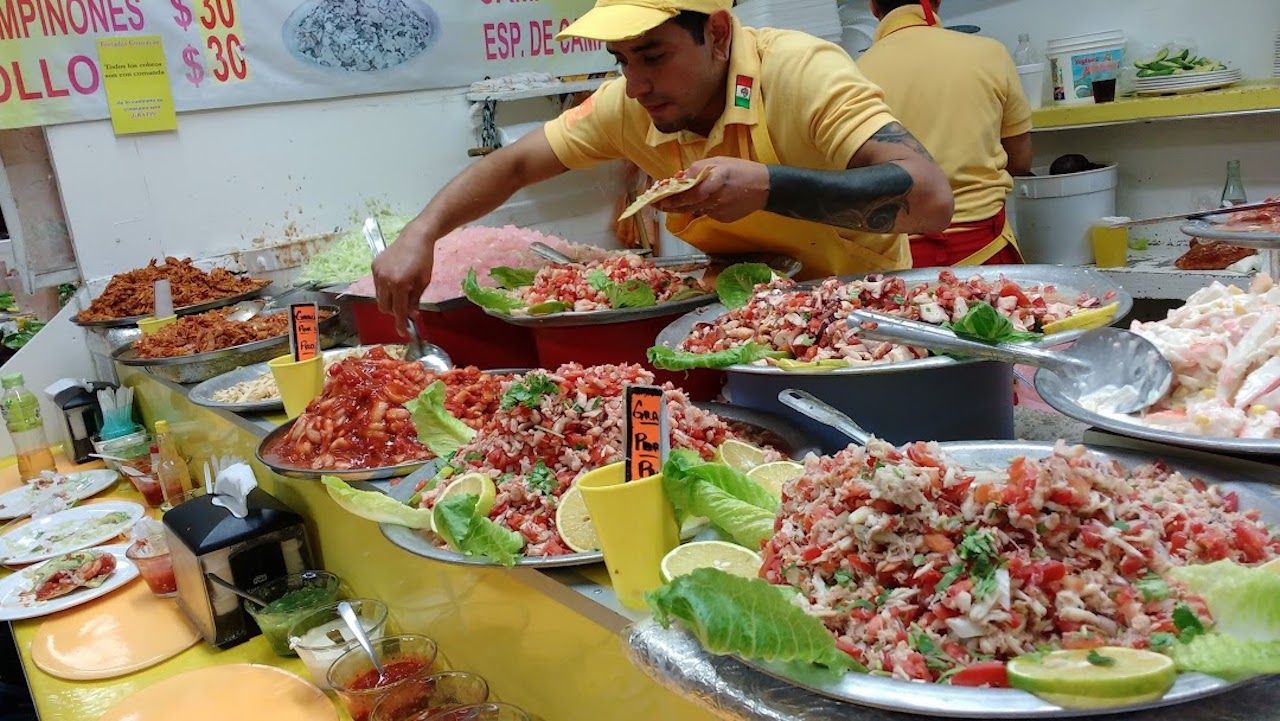 Cooks preparing food at Tostadas Coyoacán in Mexico City