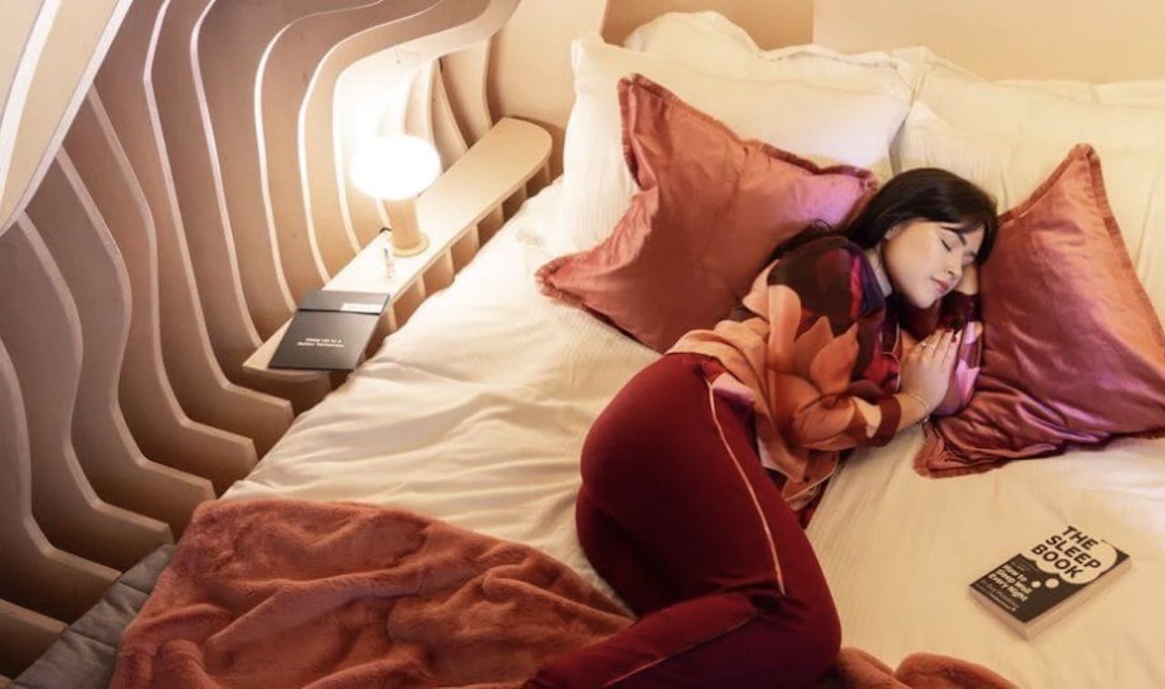 womb-like hotel room with sleeping woman