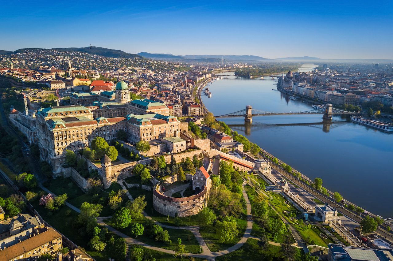 Beautiful aerial skyline view of Buda Castle Royal Palace and South Rondella at sunset with Szechenyi Chain Bridge over Danube River