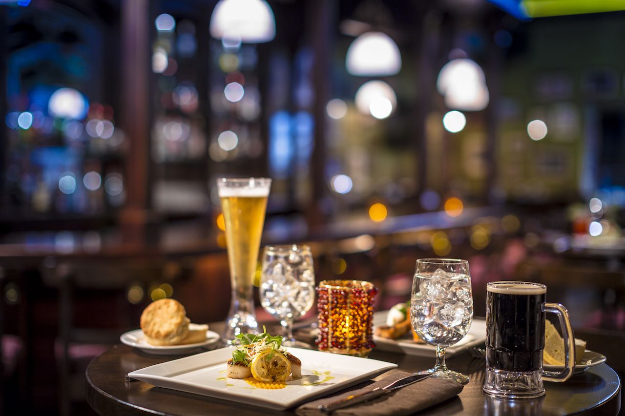 Beer and small plates on a restaurant table at a Sandals resort