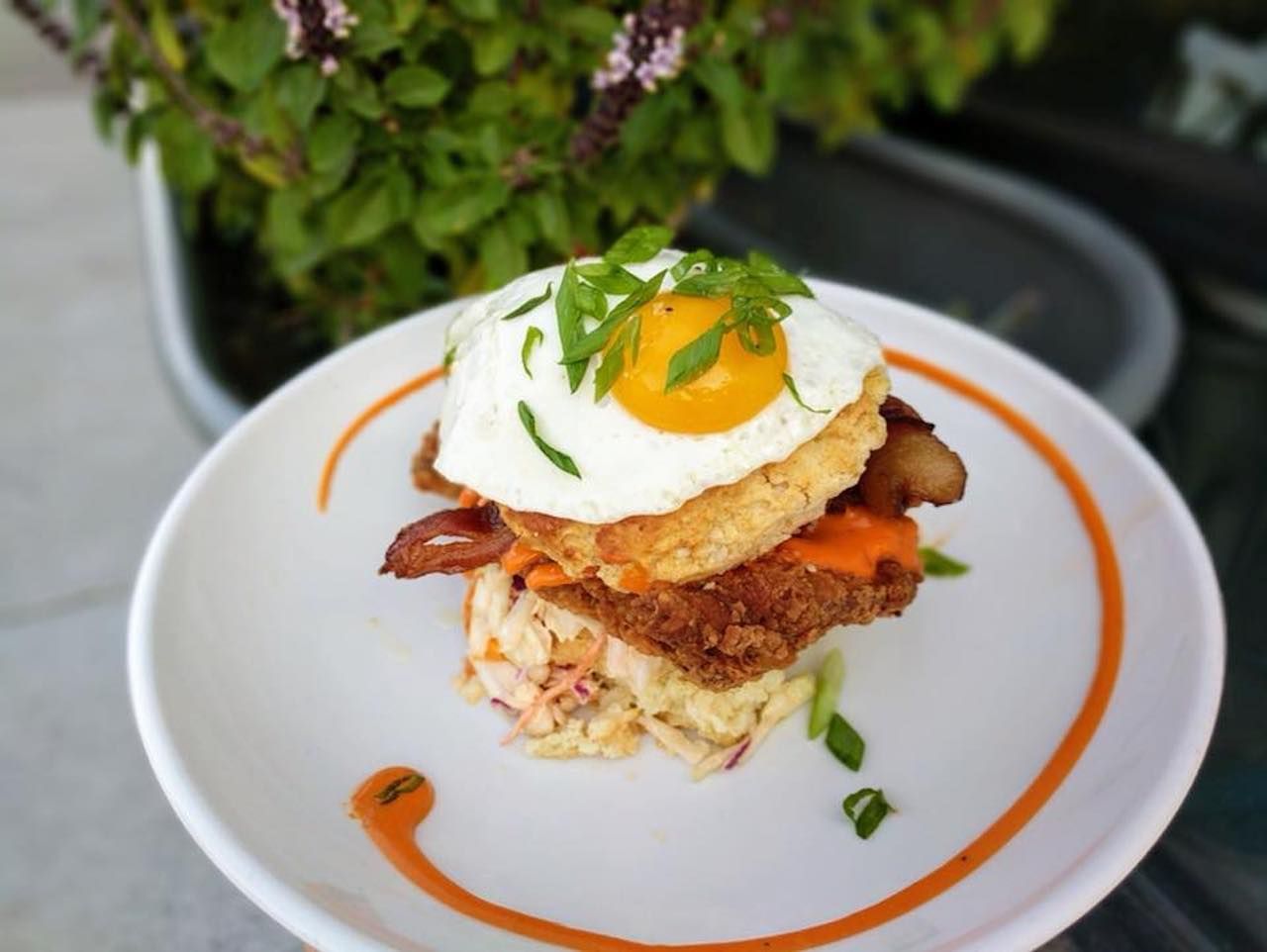 Biscuit head fried chicken sandwich topped with a fried egg