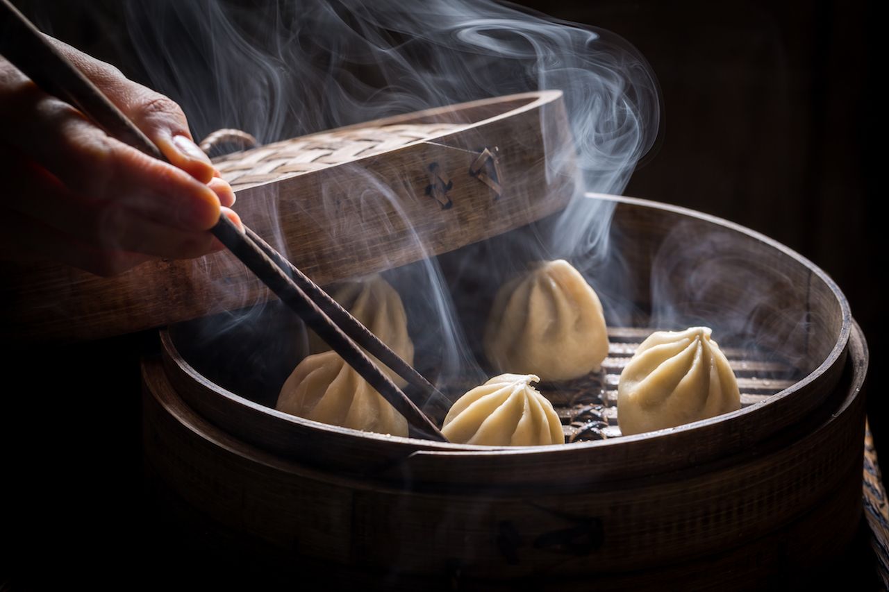 Boiled and hot chinese dumplings in wooden steamer