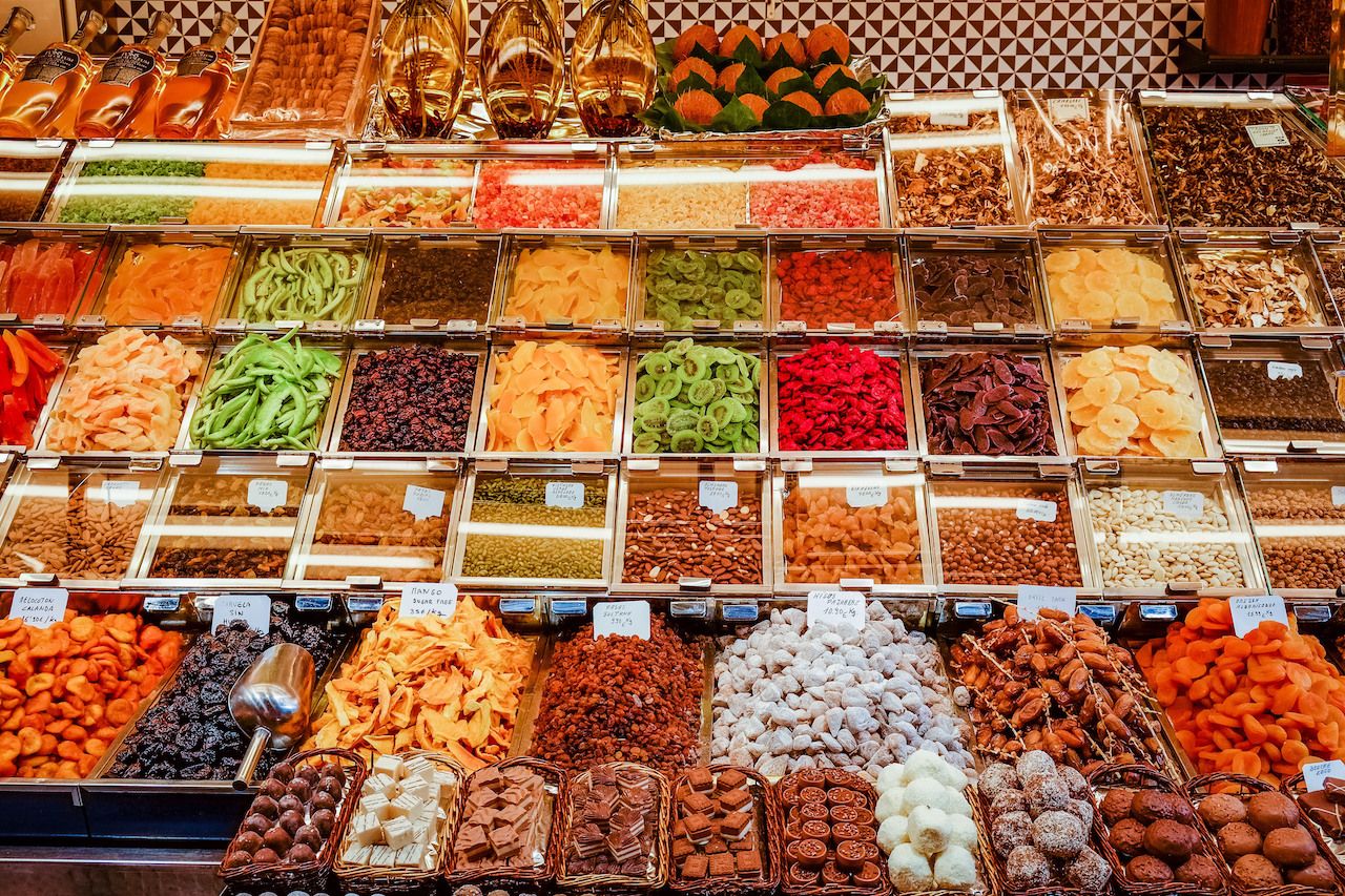 Counter with spices and dried fruit at Boqueria Market in Barcelona