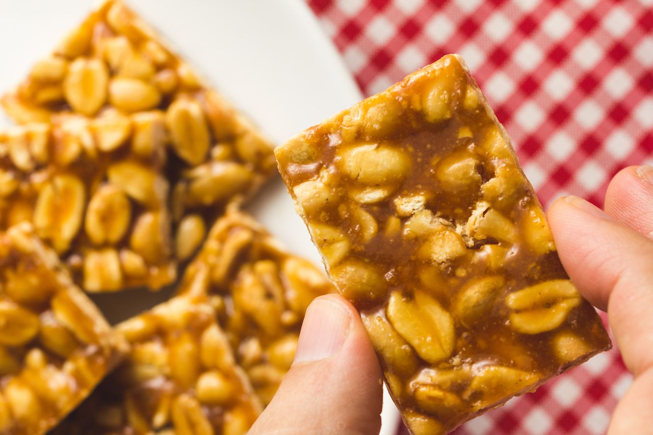 Peanut brittle from Brazil on a table with a red and white checkered tablecloth