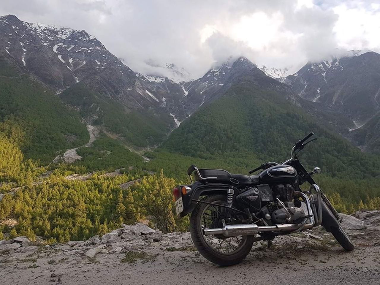 Ride The Himalayas motorcycle parked with mountains in the background