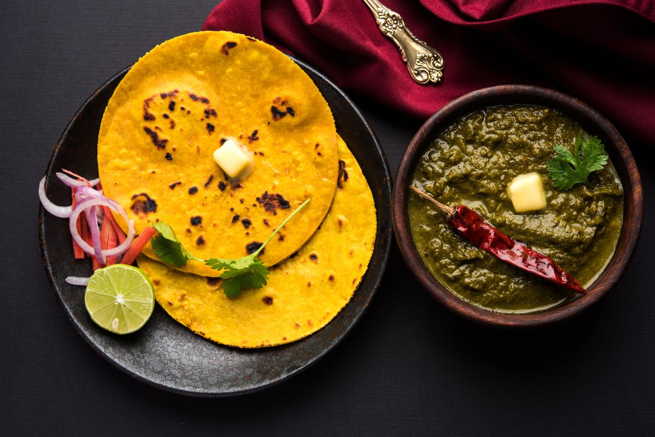 Traditional Indian mustard greens curry with flatbread