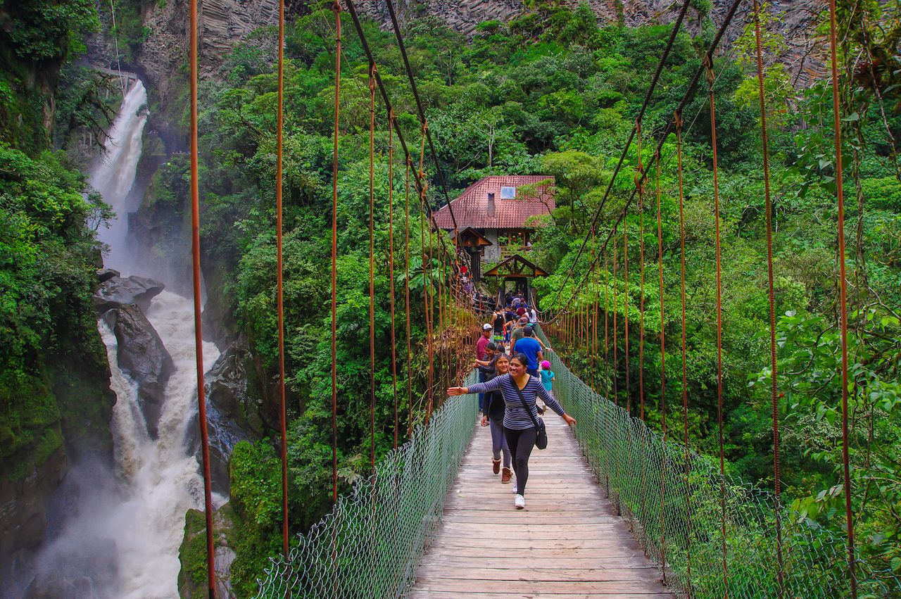 Unidentified people crossing the bridge close to Bridal Vale Manto of the Waterfall Novia in Cascade Road, Banos, Ecuador