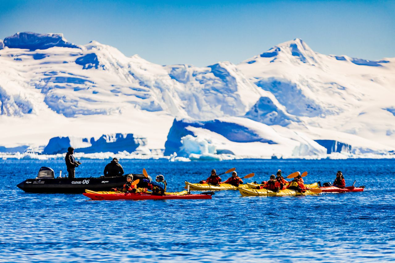 tourists kayaking in antarctic waters