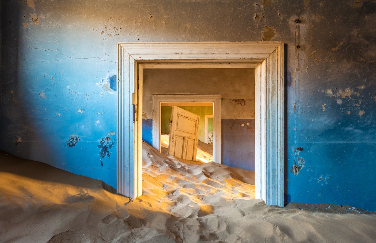 Abandoned building being taken over by encroaching sand, Kolmanskop ghost town, Namib Desert