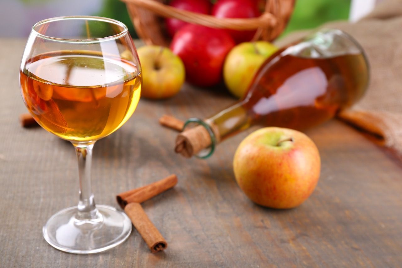 Apple cider in wine glass and bottle