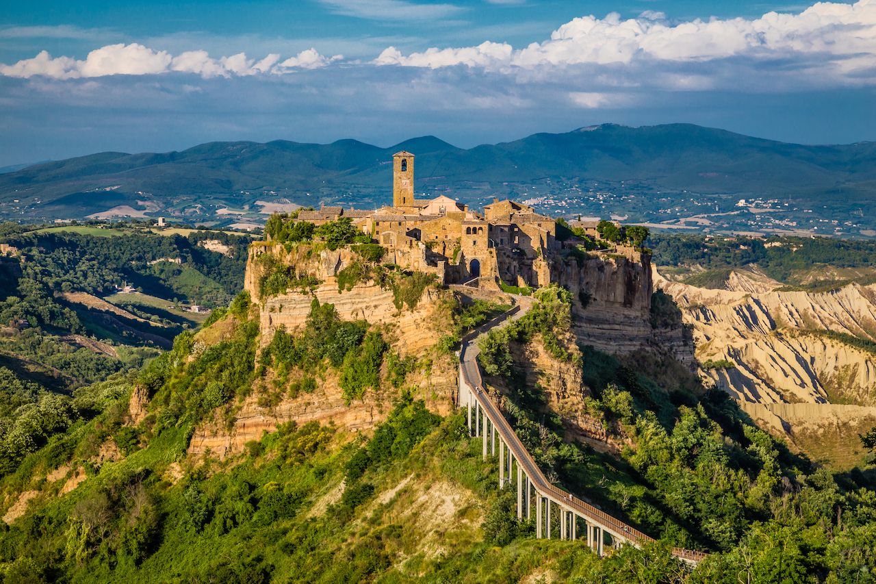 Beautiful view of famous Civita di Bagnoregio with Tiber river valley in Golden evening light at sunset, Lazio, Italy