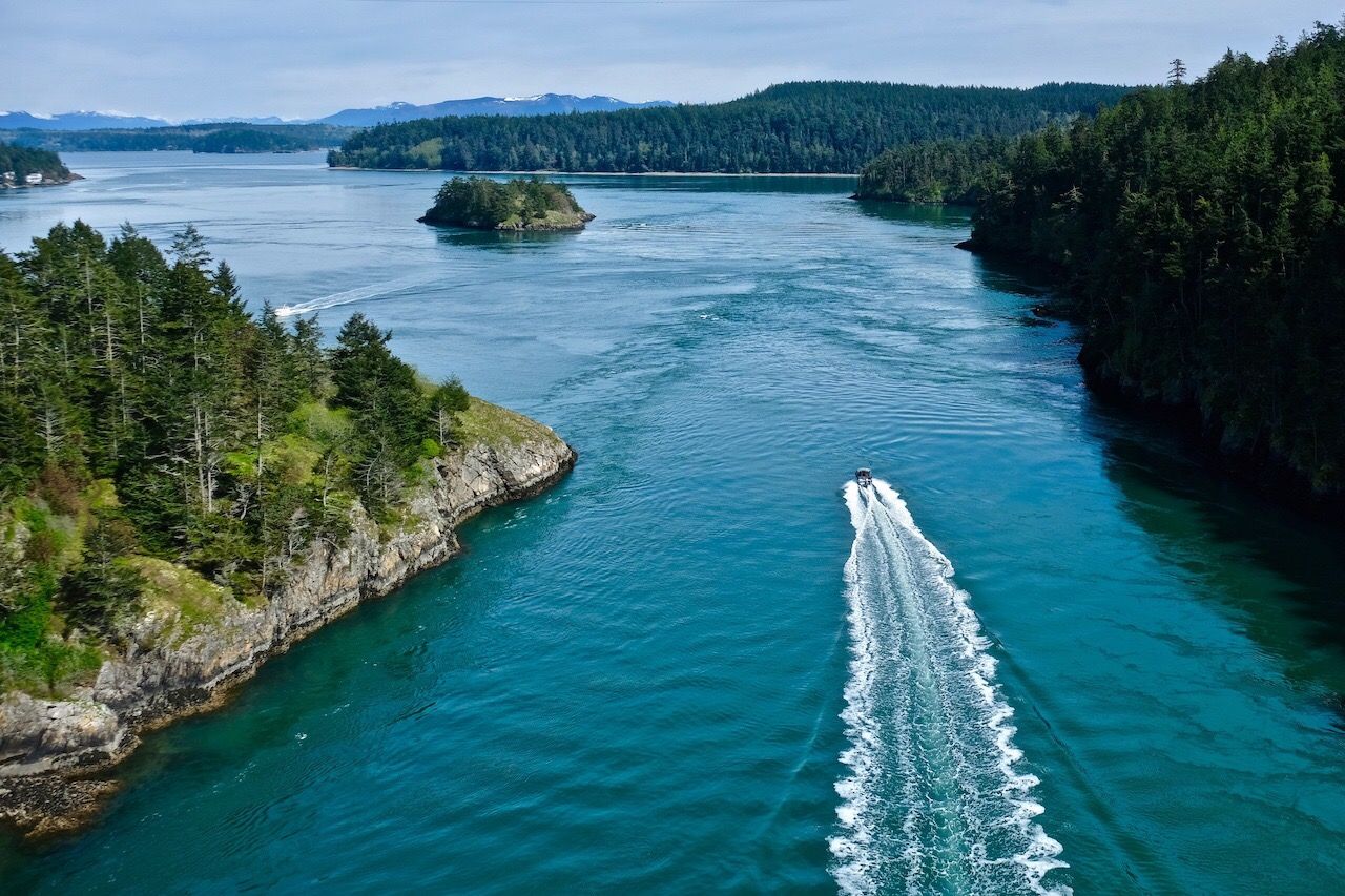 Boat in the ocean among islands. Deception Pass State Park. Puget Sound. WA