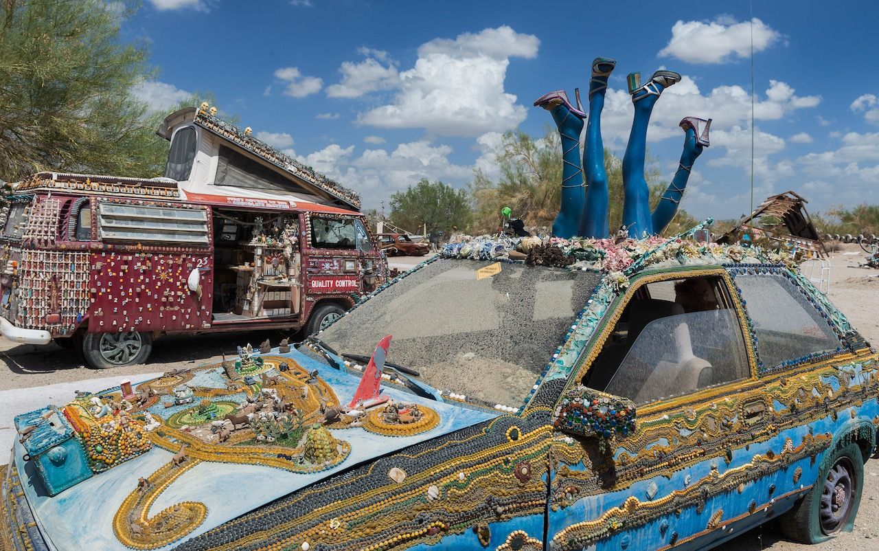 Decorated car and van in the desert in Slab City