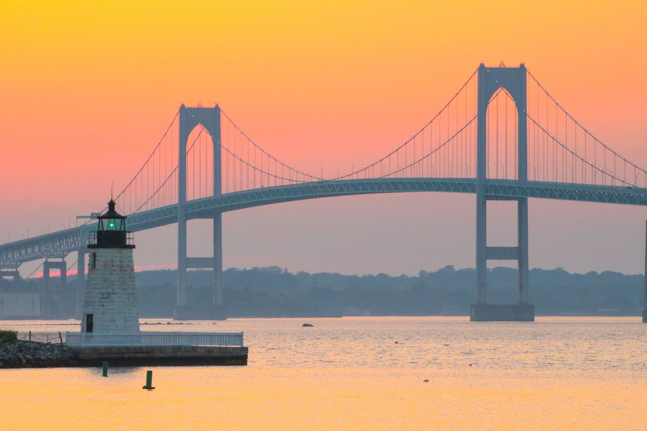 Newport Harbor Lighthouse and the Newport Bridge at sunset