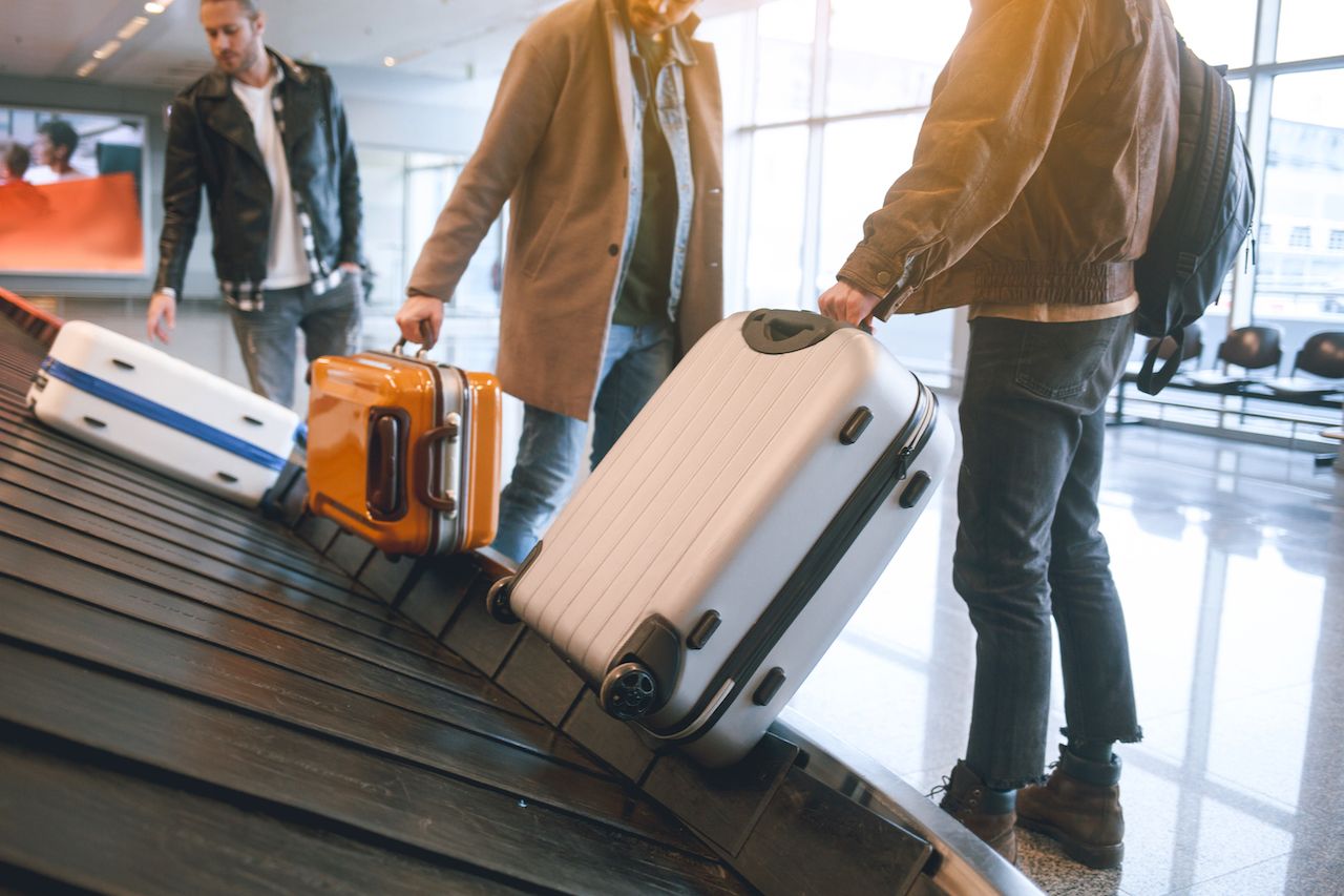 Personas recogiendo el equipaje en el aeropuerto