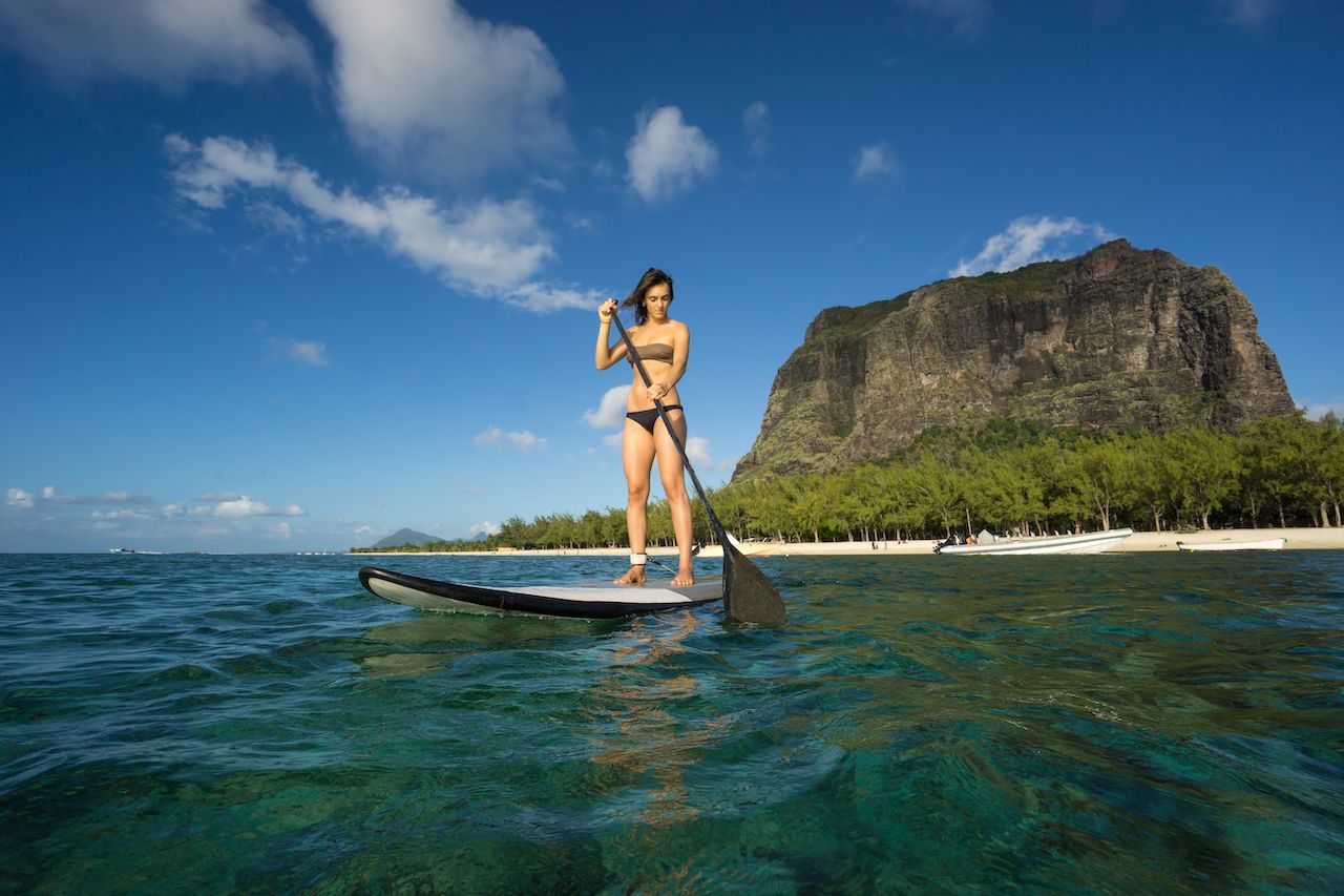 Person stand-up paddleboarding in Mauritius