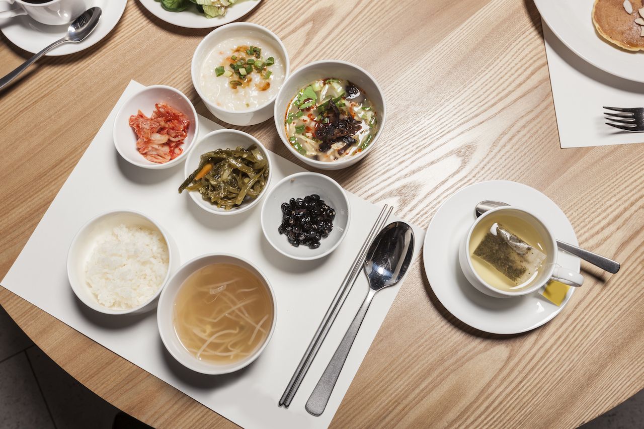 The hotel buffet breakfast food, salad, bread, egg, cornflake, coffee, han-food on the wood table in seoul, south korea