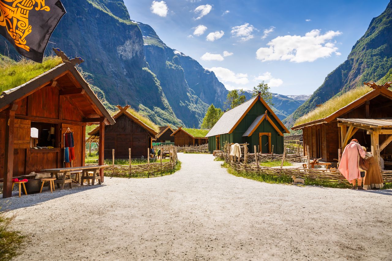 Traditional wooden houses and people in viking village museum