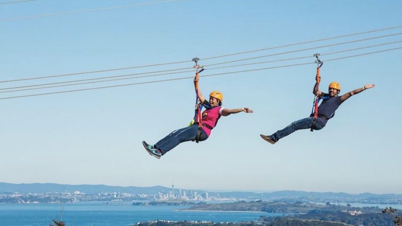 Two people zip lining in New Zealand