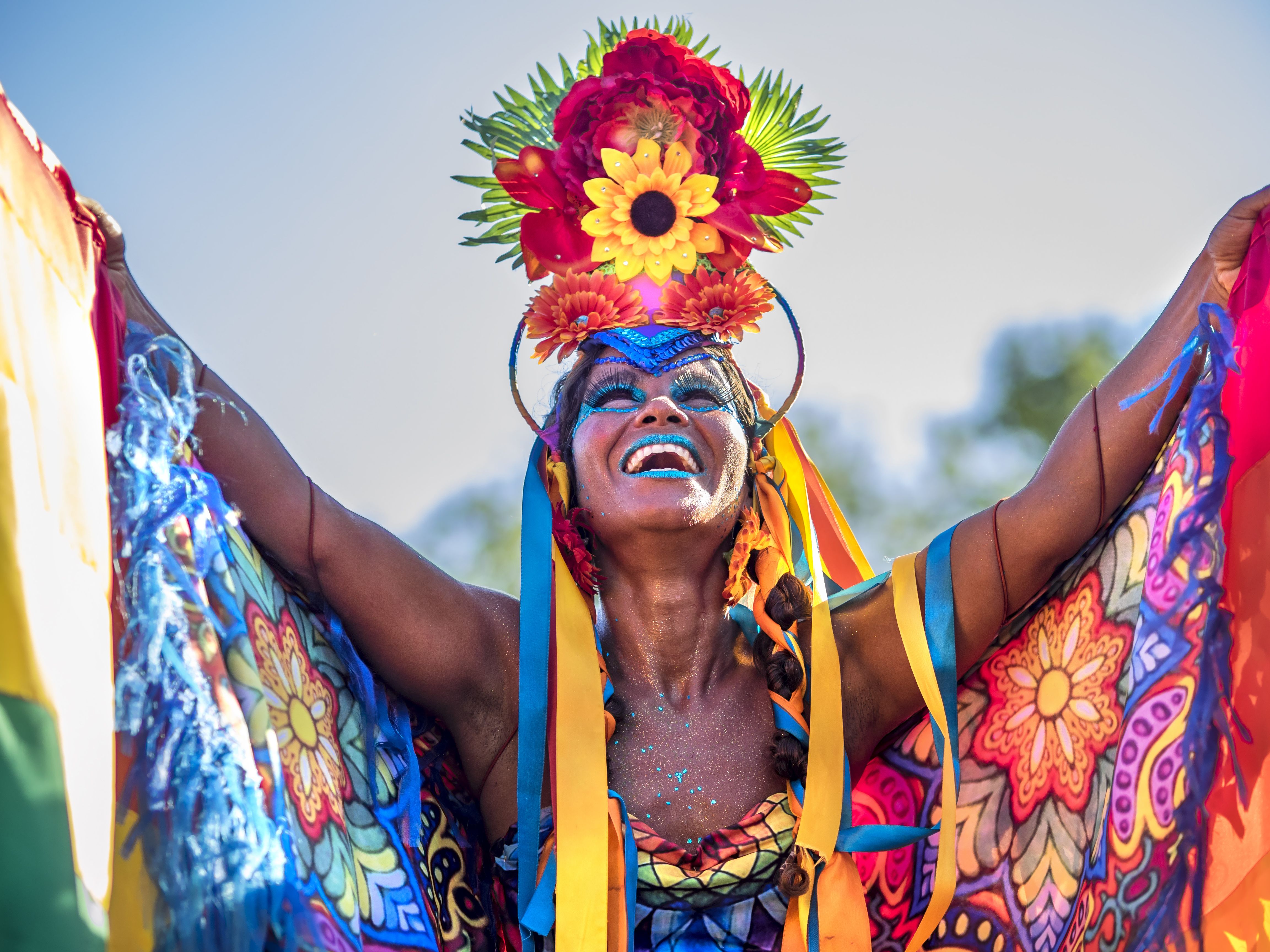Woman wearing colorful costume and smiling during Carnaval street parade in Rio de Janeiro, Brazil