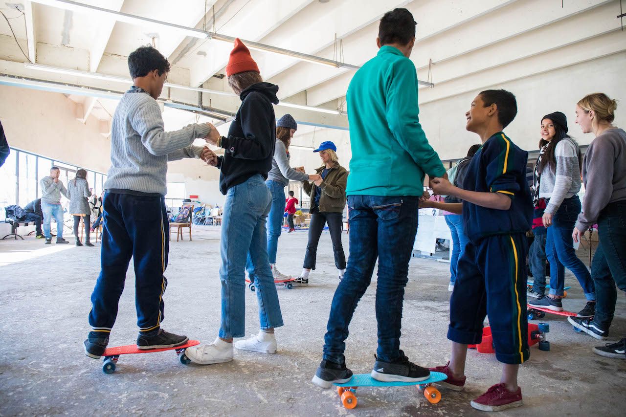 Mexican migrant kids learning to skateboard